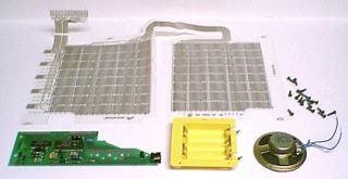 Separated case components, membrane input assemblies, board, speaker, and battery holder.