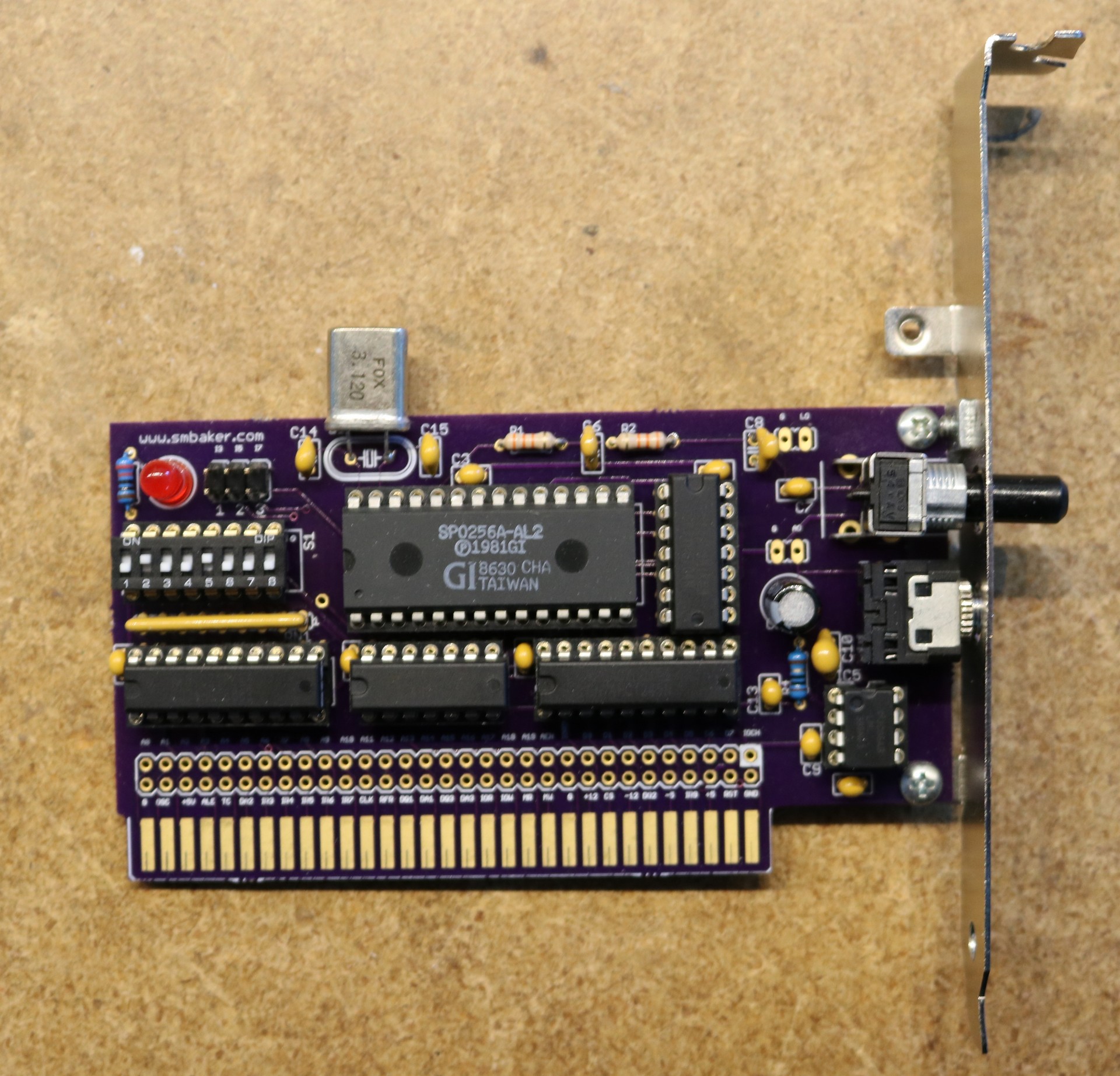 Completed ISA speech card with the SP0256A-AL2 chip prominent at the center.