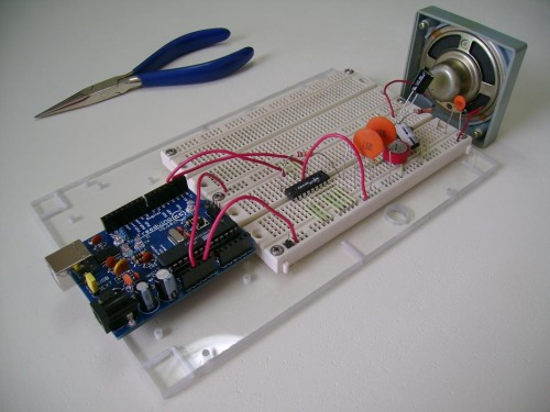 Arduino SpeakJet wired prototype on a breadboard with amplifier and speaker.